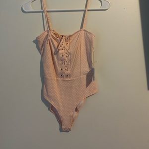 Pink polka dot body suit